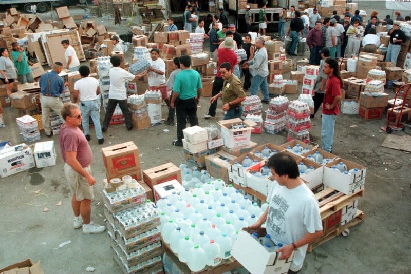 Hundreds of volunteers box up food donations for those impacted by Hurricane Mitch on November 5, 1998, in a downtown Los Angeles parking lot. The hurricane moved over the Swan Islands off the coast of Honduras on October 27, 1998, before moving on to the mainland, killing more than 10,000 people. File Photo by Jim Ruymen/UPI