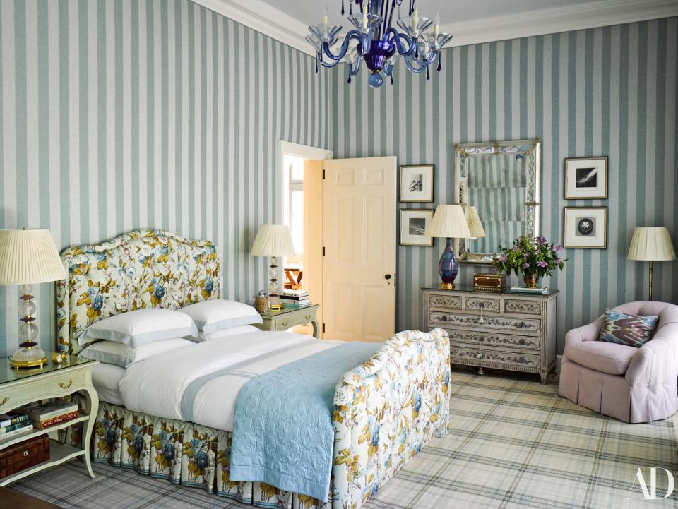 Stripes, florals, and plaid unite in a guesthouse bedroom.