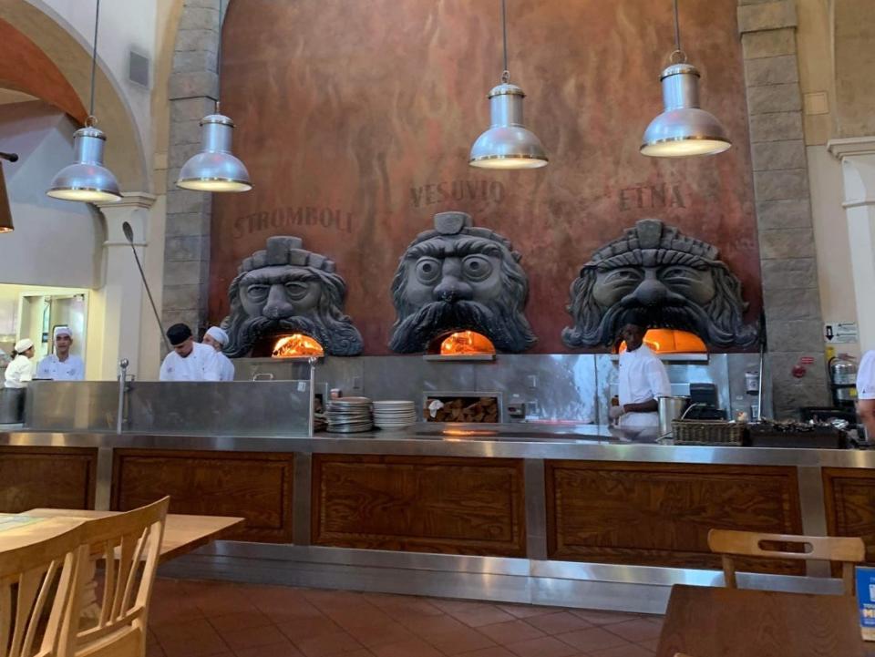 pizza ovens with faces on the walls of via napoli at disney world epcot world showcase
