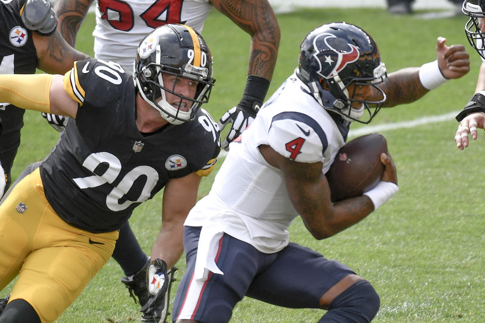Houston Texans quarterback Deshaun Watson (4) gets away from Pittsburgh Steelers outside linebacker T.J. Watt (90) during the first half of an NFL football game, Sunday, Sept. 27, 2020, in Pittsburgh. (AP Photo/Don Wright)