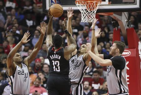 Mar 22, 2019; Houston, TX, USA;Houston Rockets guard James Harden (13) shoots against San Antonio Spurs forward Rudy Gay (22) and guard Derrick White (4) in the second half at Toyota Center. Mandatory Credit: Thomas B. Shea-USA TODAY Sports