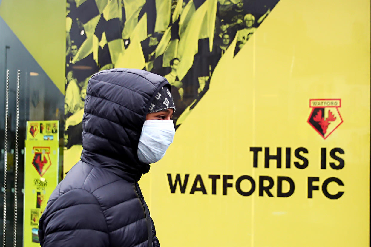 WATFORD, ENGLAND - MARCH 14: A general view outside Vicarage Road, home of Watford FC as a youth walks past wearing a protective face mask on the weekend all Premier League matches are postponed until April 3rd due to the Coronavirus Covid-19 pandemic on March 14, 2020 in London, England. (Photo by Marc Atkins/Getty Images)