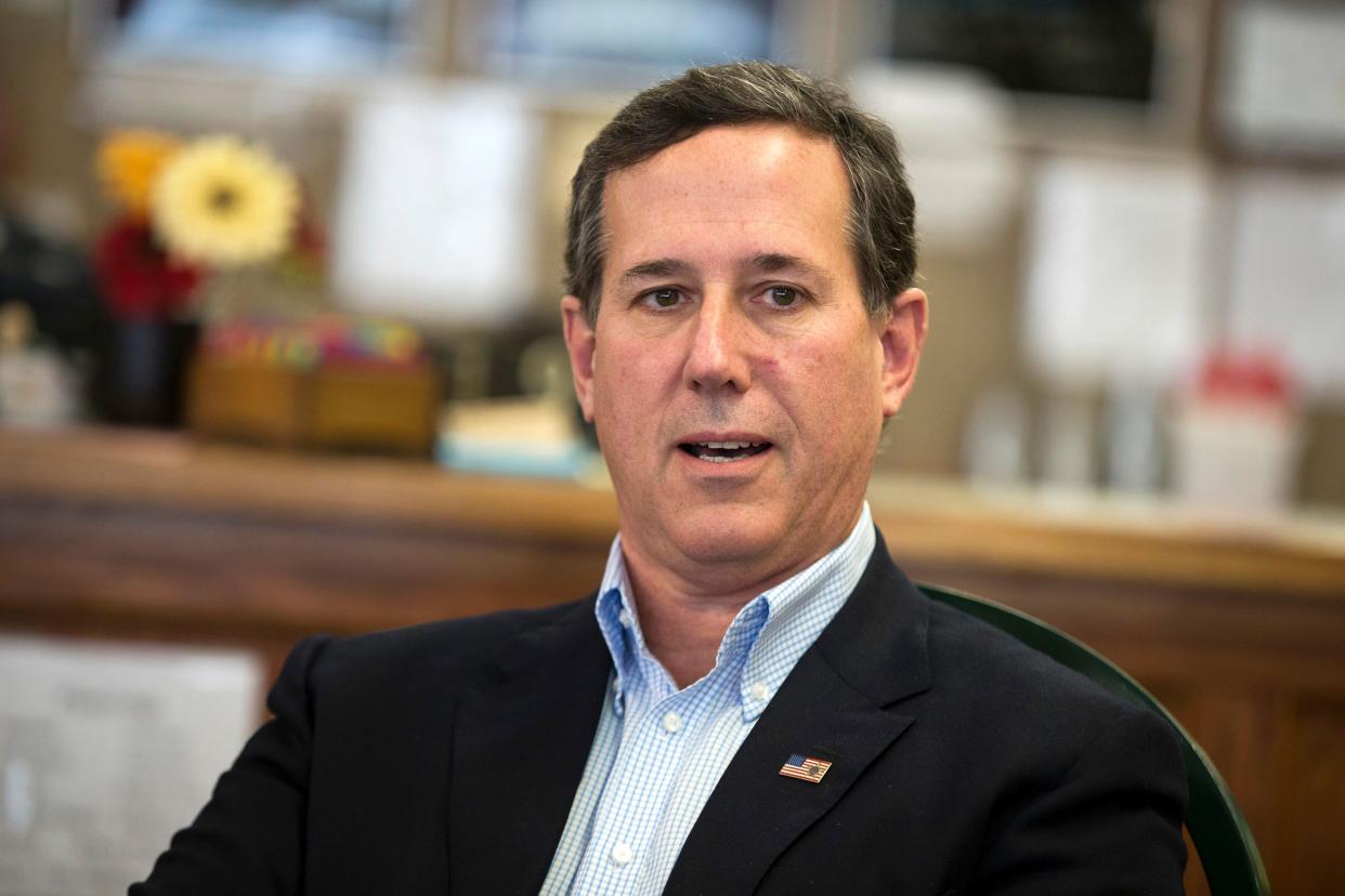 In this 2016, file photo, former Pennsylvania Sen. Rick Santorum meets with voters in Greenfield, Iowa. 