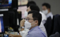 Currency traders watch computer monitors at the foreign exchange dealing room in Seoul, South Korea, Monday, Sept. 28, 2020. Asian shares were mostly higher in muted trading Monday, ahead of the first U.S. presidential debate and a national holiday in China later in the week.(AP Photo/Lee Jin-man)