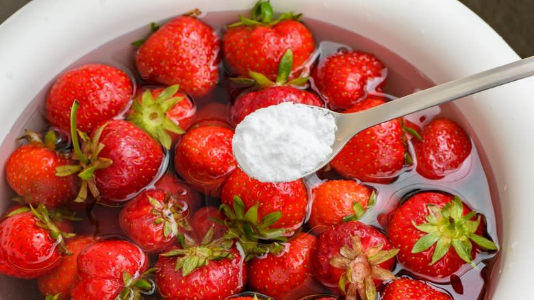 Strawberries soaking in water with baking soda