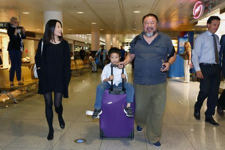 Dissident Chinese artist Ai Weiwei (R) with his son Ai Lao leave the airport in Munich, Germany July 30, 2015. REUTERS/Michaela Rehle