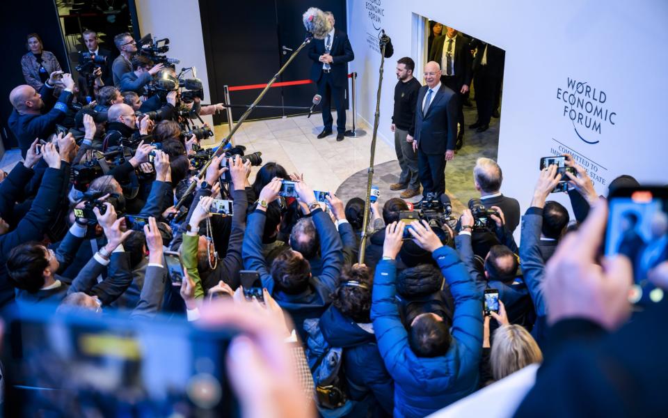 Volodymyr Zelensky and Klaus Schwab, the founder and executive chairman of the World Economic Forum, speak to the press