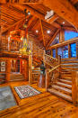 High-vaulted ceilings and open beamed ceilings help create the feeling of space while keeping the rustic inspiration of a cabin. (<a href="https://www.toptenrealestatedeals.com/weekly-ten-best-home-deals/home/mitt-romneys-utah-mountain-ski-home" rel="nofollow noopener" target="_blank" data-ylk="slk:Top Ten Real Estate Deals;elm:context_link;itc:0;sec:content-canvas" class="link ">Top Ten Real Estate Deals</a>)