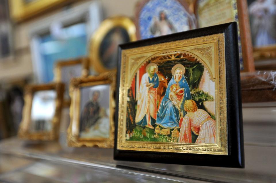 A tiny framed image of the Virgin Mary with the Baby Jesus is one of the items for sale at the Queen of Angels Catholic Store in this 2012 photo.