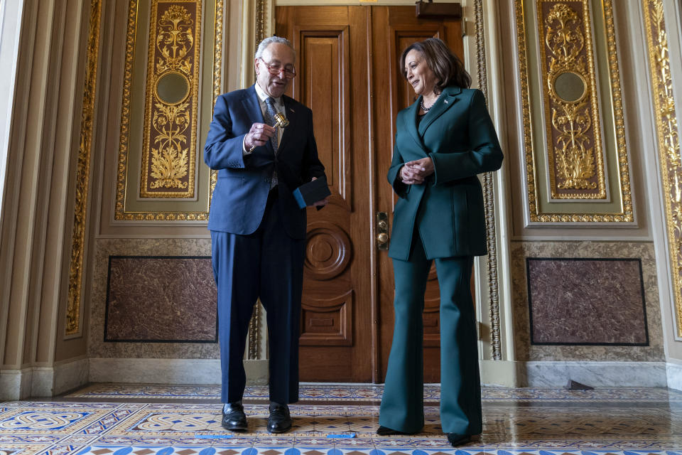 Senate Majority Leader Sen. Chuck Schumer, D-N.Y., presents Vice President Kamala Harris with a golden gavel after she cast the 32nd tie-breaking vote in the Senate, the most ever cast by a vice president, Tuesday, Dec. 5, 2023, on Capitol Hill in Washington. (AP Photo/Stephanie Scarbrough)