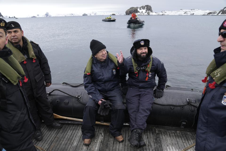 FILE - Surrounded by soldiers, Chile's President Gabriel Boric, center right, and United Nations Secretary-General Antonio Guterres sit on a boat during an official visit to Chile's Eduardo Frei Air Force Base at King George Island, South Shetlands, Antarctica, Nov. 23, 2023. Guterres, numerous climate scientists and environmental activists all say what’s needed is a phase-out — or at the very least a phase-down — of coal, oil and gas. (AP Photo/Jorge Saenz, File)