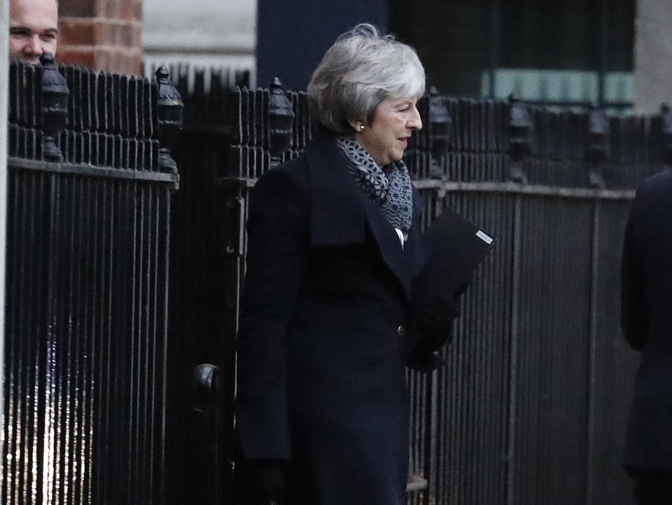 Britain's Prime Minister Theresa May leaves 10 Downing Street in London, Monday, Jan. 14, 2019. B May offered both a promise on workers' rights and a reassuring letter from European Union leaders on Monday as she implored British lawmakers to support her floundering Brexit deal. (AP Photo/Frank Augstein)