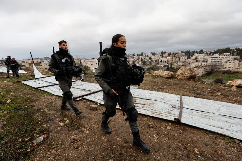 Israeli security forces walk at the site of a demolished house in the Sheikh Jarrah neighbourhood of East Jerusalem