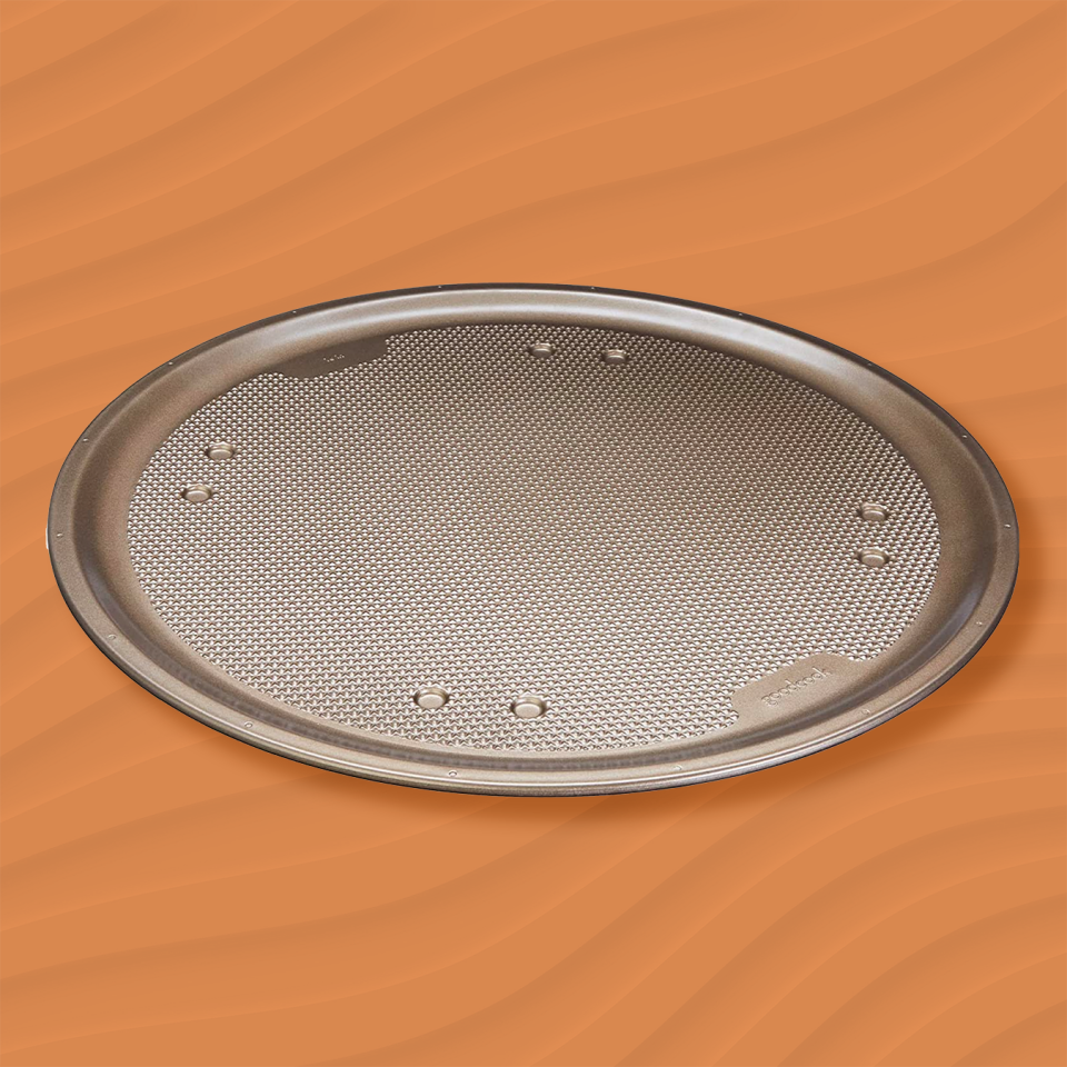 the goodcook textured pizza pan against an orange wavy background