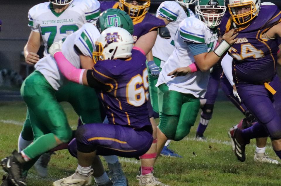 Monty Tech defensive end Cam Begnoche (No. 69) sheds a block and moves in to tackle Sutton running back Declan O’Callaghan (No. 3) during a game Friday, October 6, 2023. Sutton won, 21-8.