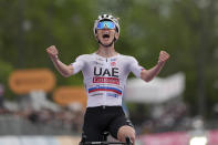 Tadej Pogačar celebrates as he cycles to the finish line to win stage 2 of the Giro d'Italia from San Francesco al Campo to Santuario di Oropa, Italy, Sunday, May 5, 2024. (Massimo Paolone/LaPresse via AP)