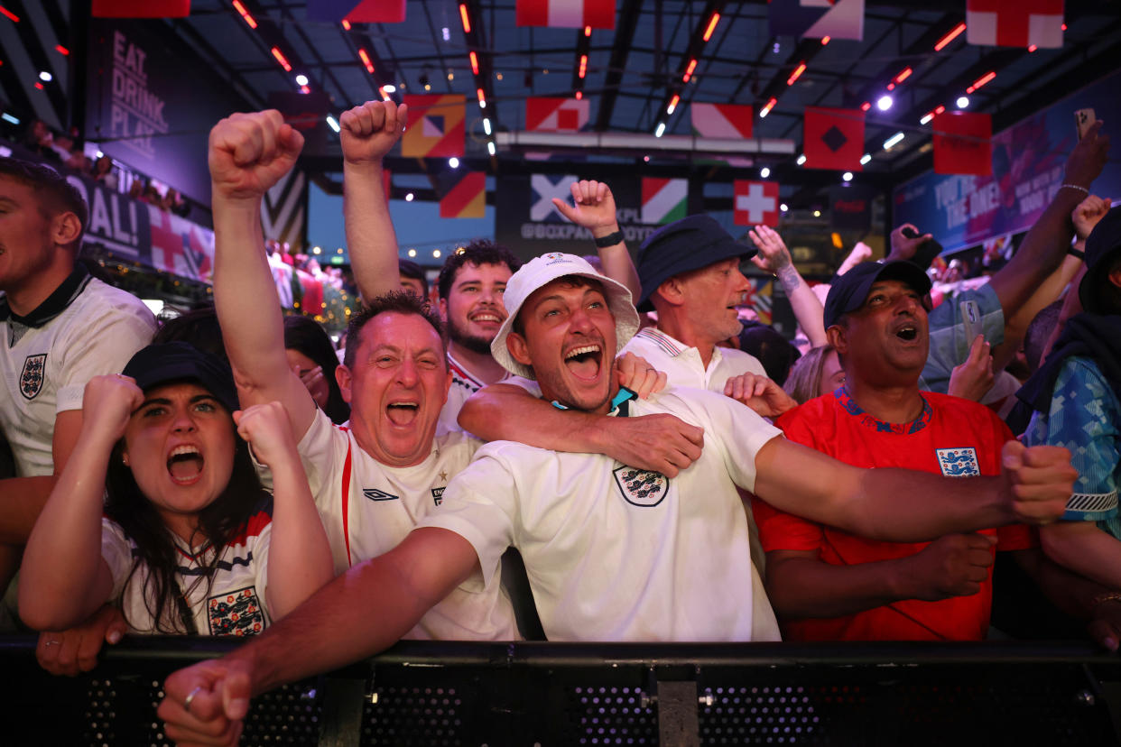 LONDON, ENGLAND - JULY 10: England fans celebrate after Ollie Watkins of England scores and England win 2-1 while watching the UEFA EURO 2024 semi-finals match between England and Netherlands at Boxpark Croydon on July 10, 2024 in London, England. England face the Netherlands at BVB Stadion in Dortmund after advancing with a 5-3 penalty win over Switzerland on Saturday. (Photo by Dan Kitwood/Getty Images)