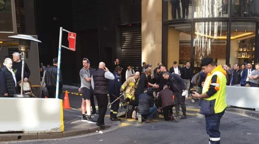 Handout photo taken with permission from the Twitter feed of @thisisbrodie of a man being tackled with a milk crate and chairs by members of the public in Sydney, Australia.