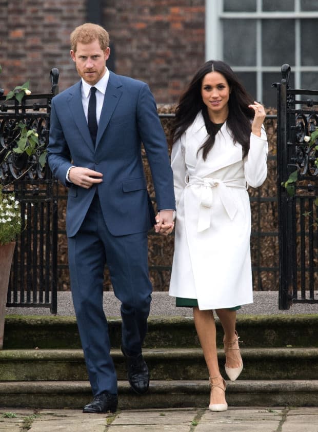 <p>The $840 white coat in which Meghan posed for her engagement photocall in <a href="https://parade.com/living/november-holidays-observances" rel="nofollow noopener" target="_blank" data-ylk="slk:November;elm:context_link;itc:0;sec:content-canvas" class="link ">November</a> 2017 alongside her new fiancée was by The Line and subsequently sold out so fast it crashed the designer's website. Since the day that Harry and Meghan posed in the Sunken Garden—which months before had been replanted with white flowers in Princess Diana's memory—the coat has gone on to achieve iconic status. Meghan also wore a pair of opal stud earrings by Birks. Many people consider opals unlucky, but for some cultures, they're a symbol of hope.</p>