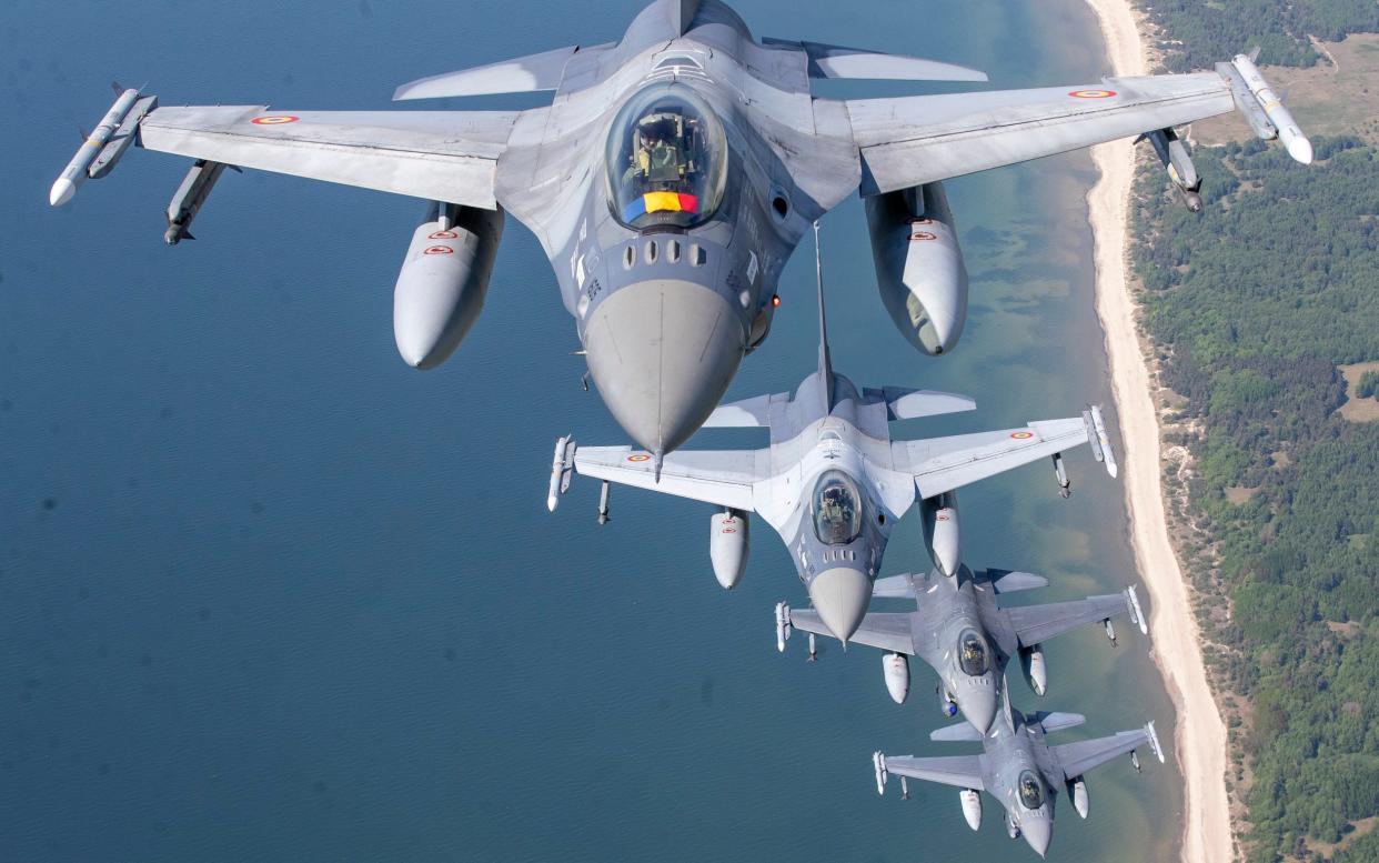 A Romanian Air Force F- 16s military fighter jet, in front, and Portuguese Air Force F- 16s military fighter jets participating in Nato's Baltic Air Policing Mission operate over the Baltic Sea - Mindaugas Kulbis/AP