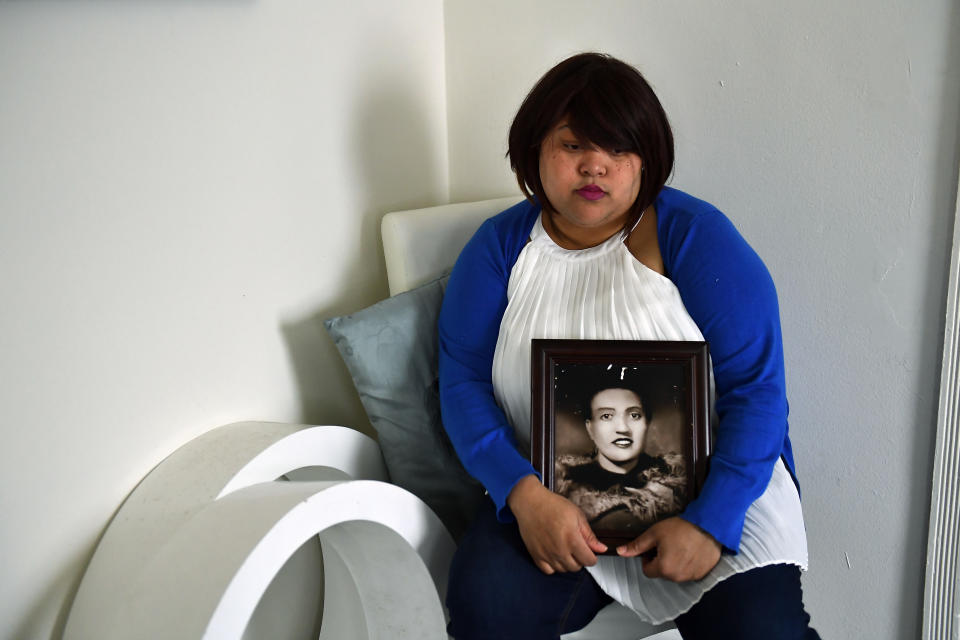 Veronica Spencer, great-granddaughter of Henrietta Lacks, holds a framed photo of Henrietta Lacks.