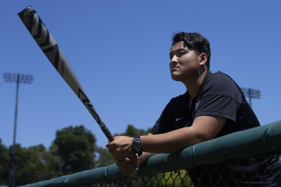 Rintaro Sasaki poses for photos at the Sunken Diamond baseball field at Stanford University in Stanford, Calif., Friday, May 31, 2024. Slugging first baseman Sasaki hit 140 high school home runs back home in Japan and opted out of the Nippon Professional Baseball draft in order to take his own unique path. He is attending college in the U.S. and will be beginning his summer ball this week in New Jersey playing for Trenton of the MLB Draft League. (AP Photo/Jeff Chiu)