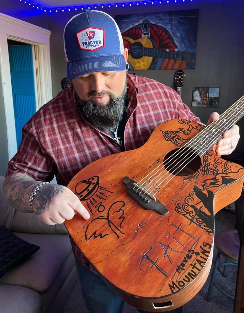 Aaron Hymes, a Paris Township resident and Christian country music artist, is shown at his home where he rehearses with his band, which recently signed a Nashville recording contract.