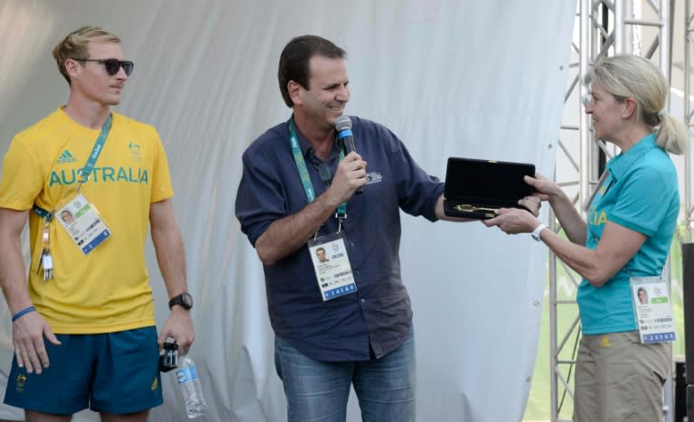 Rio's Mayor Eduardo Paes (C) gives the keys the city to Kitty Chiller (R), Australia's Chief of Mission for the Rio 2016 Olympic Games, at the Olimpic Village in Rio de Janeiro, Brazil on July 27, 2016