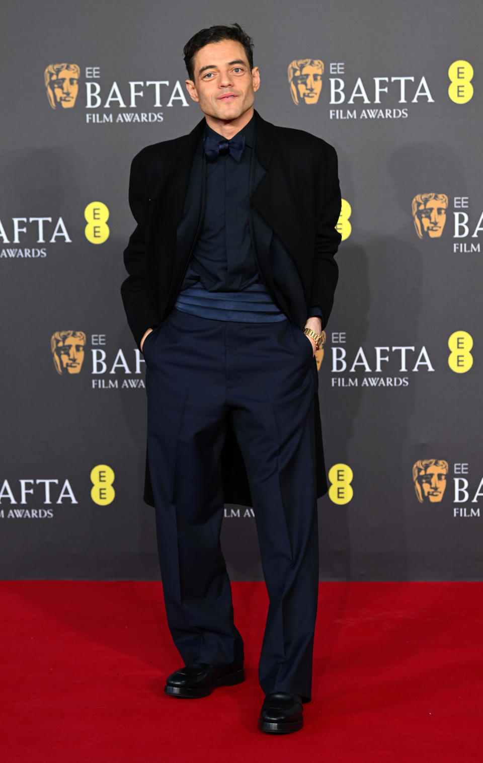 Rami Malek in a black suit with bow tie at the BAFTA Film Awards