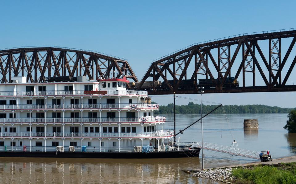 A train speeds by on the Henderson Bridge as the Queen of the Mississippi is dock on the Henderson Riverfront Wednesday, June 26, 2019. 