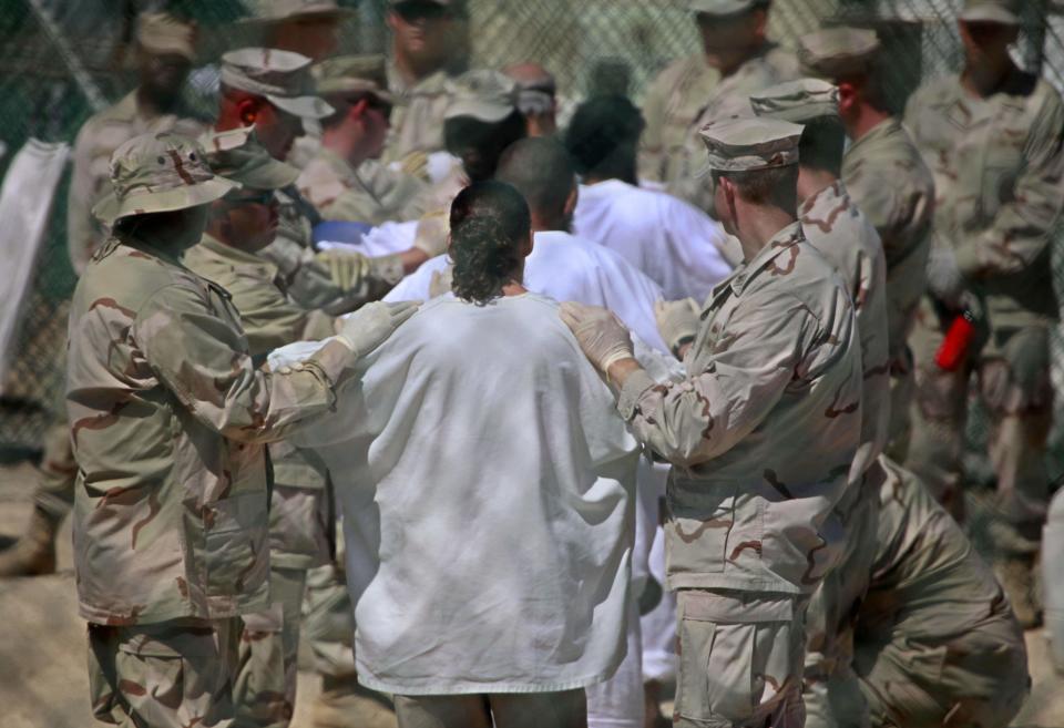 Image: Detainees at Guantanamo Bay (Brennan Linsley / AP file)