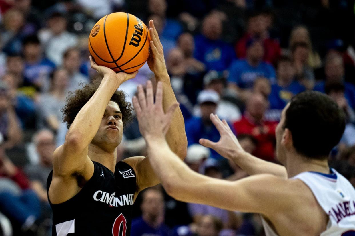 Cincinnati Bearcats guard Dan Skillings Jr. (0) hits a 3-point basket  in UC's 72-52 win over Kansas in the Big 12 tournament.