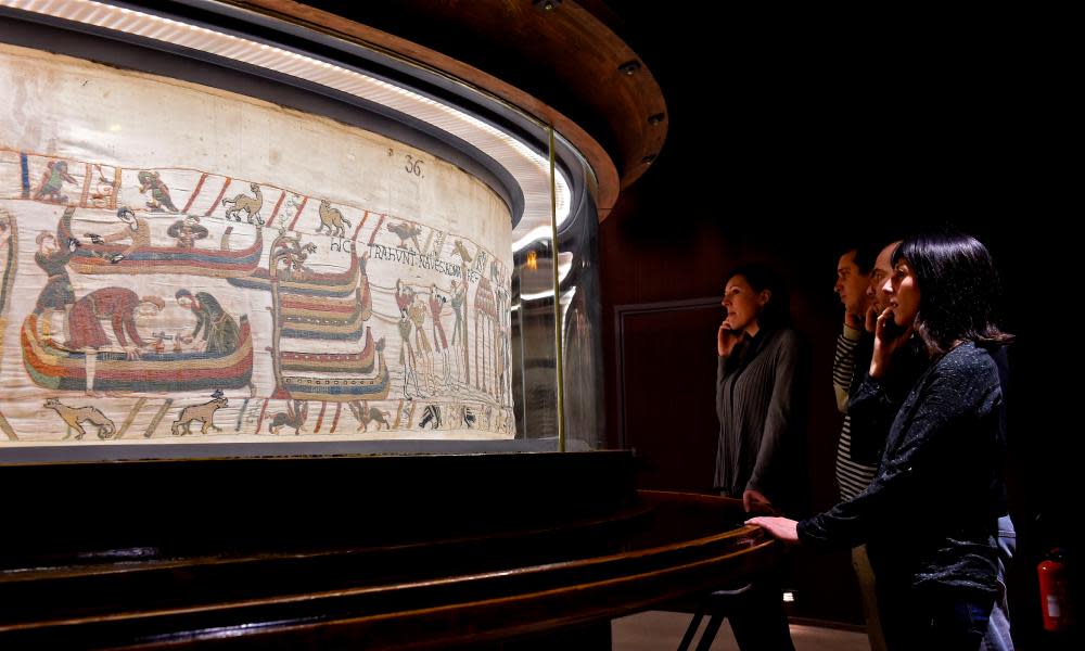 Visitors looking at the Bayeux Tapestry, which dates from around 1077 and depicts the Battle of Hastings when William the Conqueror, the duke of Normandy, defeated English forces in southern England.