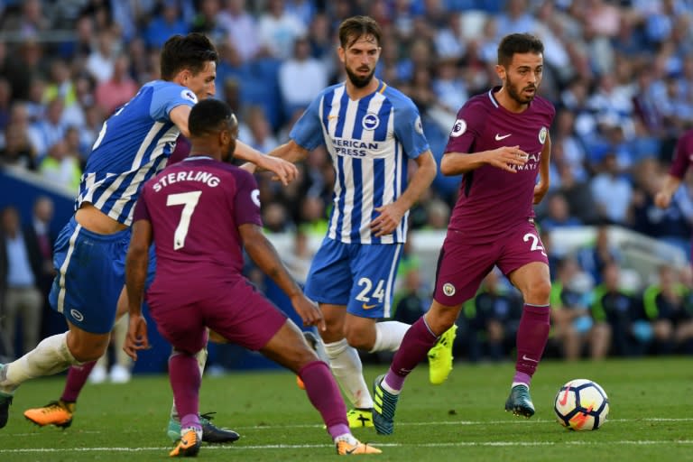 Manchester City's Bernardo Silva (R) runs with the ball during their English Premier League match against Brighton & Hove Albion, at the American Express Community Stadium in Brighton, on August 12, 2017