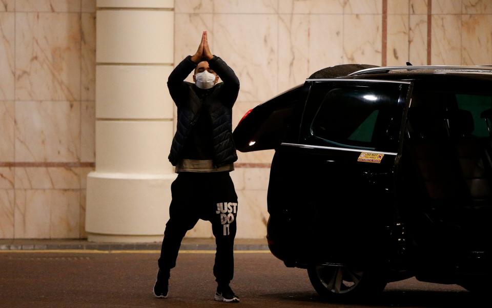 A traveller leaves the Radisson Blu hotel after completing the quarantine period - Hollie Adams/Getty