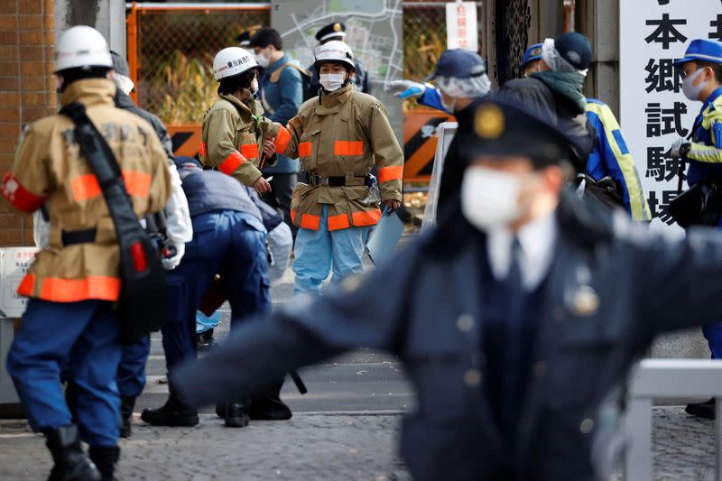 Emergency personnel are seen at the site where a stabbing incident happened at an entrance gate of Tokyo University in Tokyo