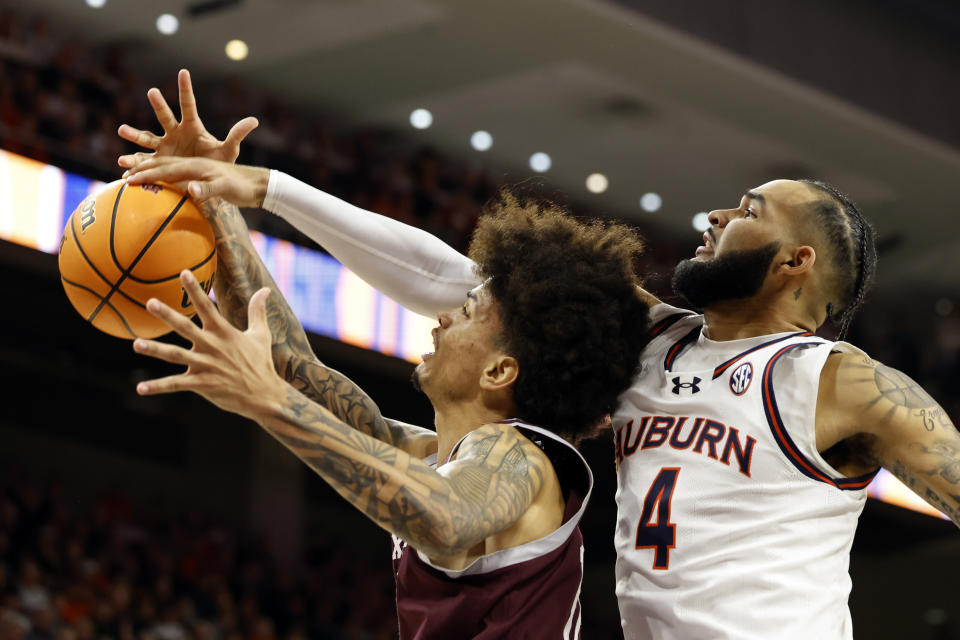 Texas A&M forward Andersson Garcia (11) is fouled by Auburn forward Johni Broome (4) as he shoots during the first half of an NCAA college basketball game Tuesday, Jan. 9, 2024, in Auburn, Ala. (AP Photo/Butch Dill)