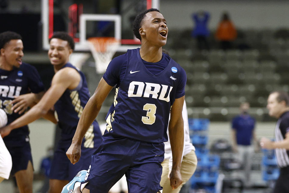 INDIANAPOLIS, INDIANA - MARCH 21: Max Abmas #3 of the Oral Roberts Golden Eagles celebrates with teammates after defeating the Florida Gators in the second round game of the 2021 NCAA Men's Basketball Tournament at Indiana Farmers Coliseum on March 21, 2021 in Indianapolis, Indiana. Oral Roberts defeated Florida 81-78. 