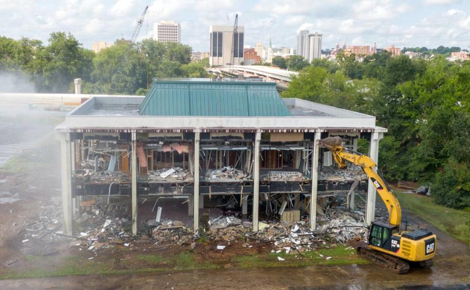 A Macon-Bibb County excavator begins the tear down of the former Greater Chamber of Commerce building Wednesday morning located at 305 Coliseum Drive. The removal of the building will increase parking for the Macon Coliseum.