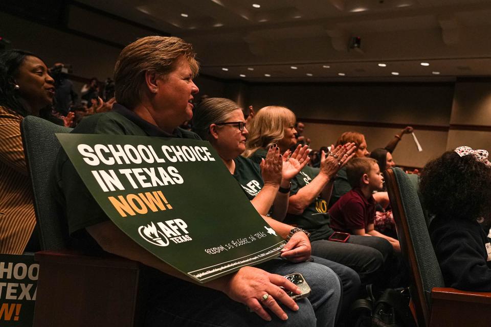 Kandace Raymond, grassroots engagement director for Americans for Prosperity, listens to Texas Governor Greg Abbot speak at a Parent Empowerment Rally in the auditorium of the Texas Capitol on Monday, Oct. 16, 2023.