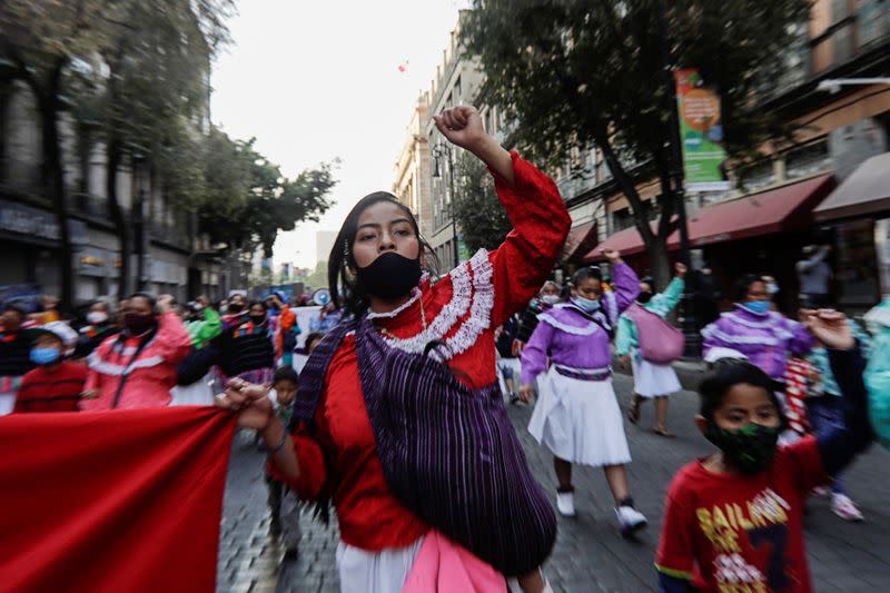 A woman raises her fist during a protest to mark the International Day for the Elimination of Violence against Women, in Mexico City