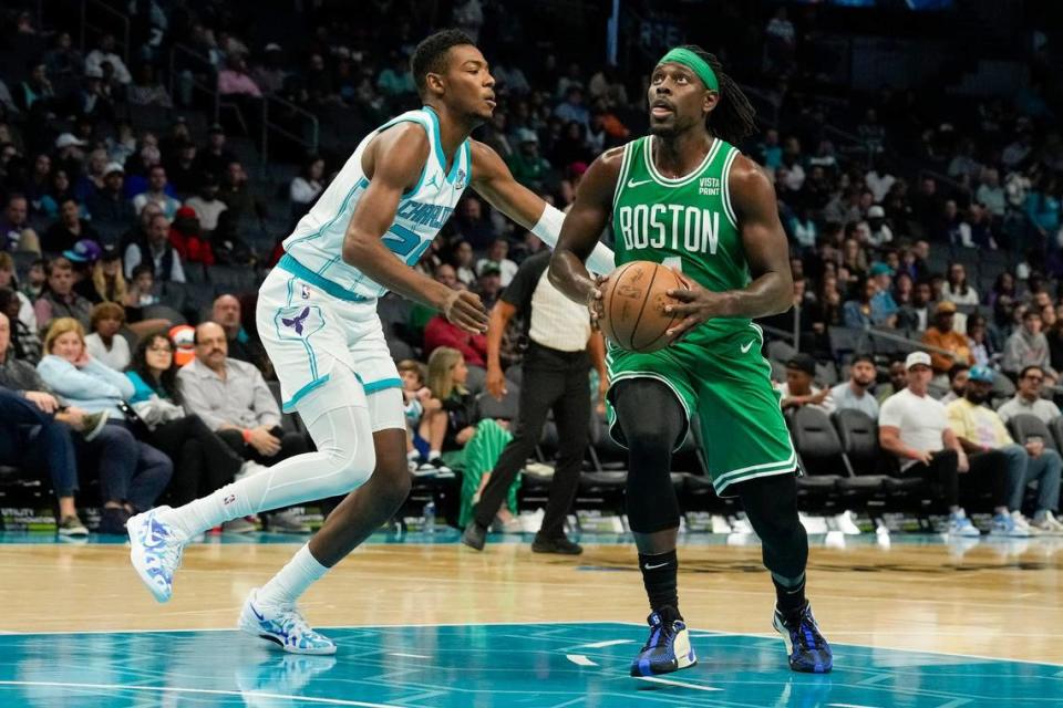 Boston Celtics guard Jrue Holiday (4) looks to the basket guarded by Charlotte Hornets forward Brandon Miller (24) during the first quarter at Spectrum Center.