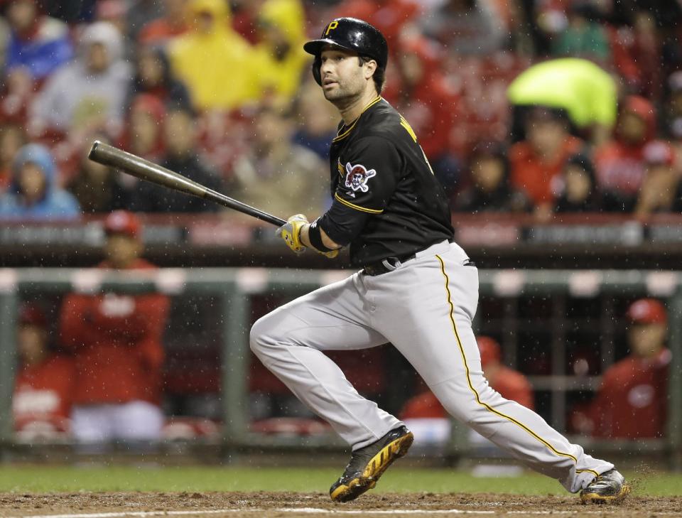 Pittsburgh Pirates' Neil Walker gets a hit off Cincinnati Reds starting pitcher Homer Bailey in the fourth inning of a baseball game, Monday, April 14, 2014, in Cincinnati. (AP Photo/Al Behrman)