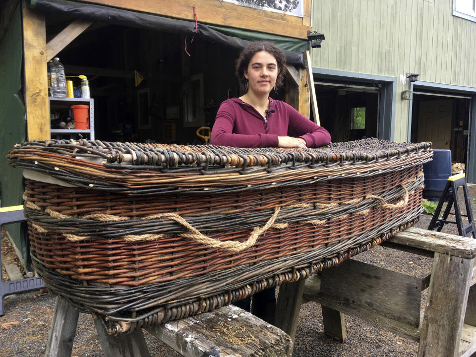 Mary Lauren Fraser stands beside a biodegradable casket she hand-wove from willow, in Montague, Massachusetts. (Photo: ASSOCIATED PRESS)