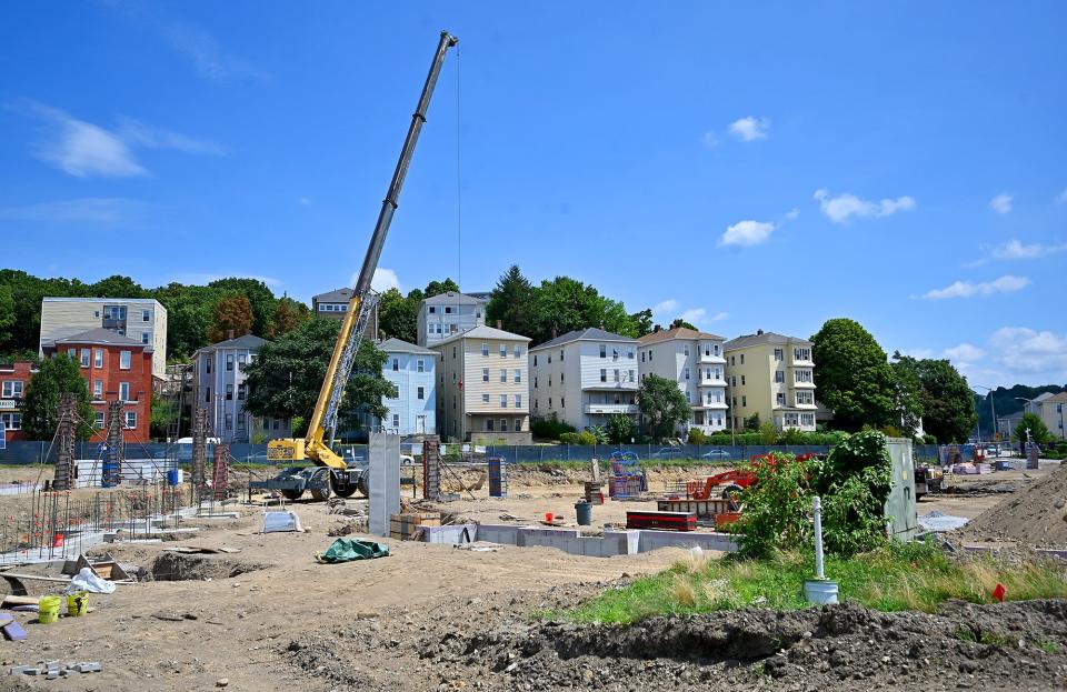 Work continues on the opposite side from a parking garage under construction at the site of the former Our Lady of Mount Carmel Church Tuesday.