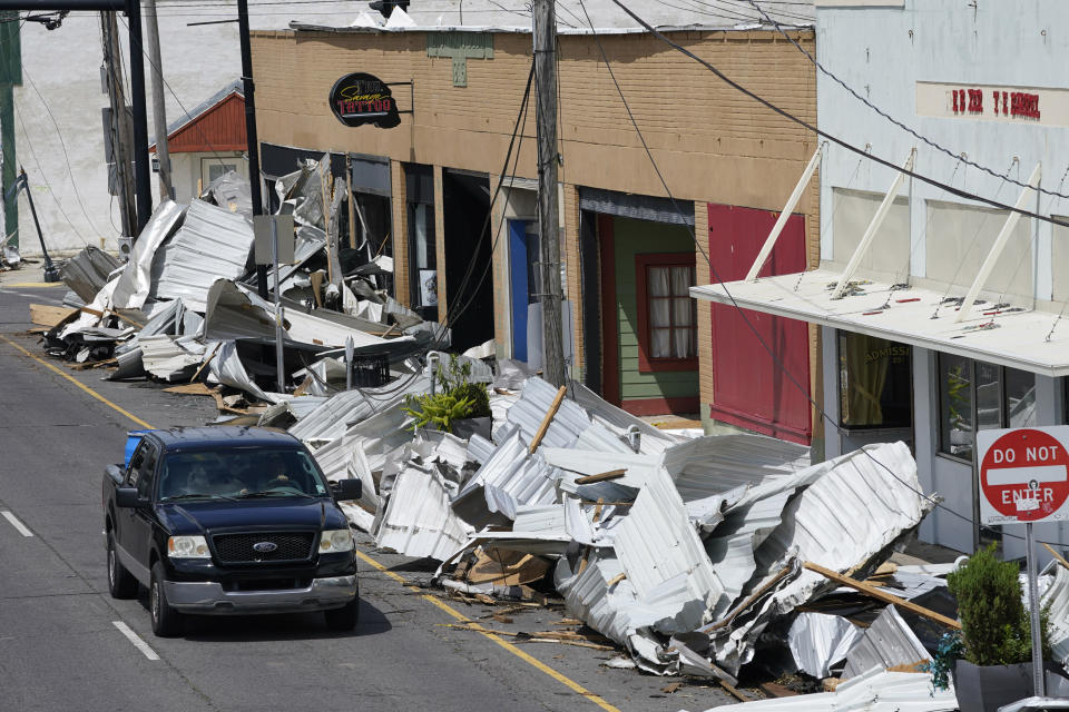 Traffic passes by piles of debris on the sidewalk of Main Street in downtown as residents and try to recover from the effects of Hurricane Ida Tuesday, Aug. 31, 2021, in Houma, La. (AP Photo/Steve Helber)