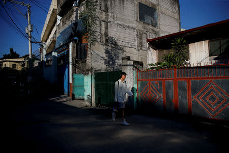 Oliver Emocling, 23, who works for a magazine, leaves his neighbourhood in Caloocan City, Metro Manila, Philippines, November 29, 2018. Because of the long travel hours, Emocling not only lacks sleep, but also misses meals. "I usually don't get to eat breakfast or dinner unless I wake up really early, or eat out. When I get home, it's already 10 p.m., and my body is just craving sleep rather than food," he said. REUTERS/Eloisa Lopez