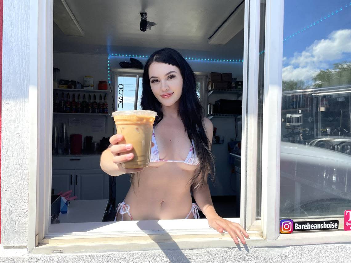 Bare Beans Bikini Coffee co-owner Kylie Ongstad (who uses co-owner/fiance Braden Nelson’s last name) passes a Dirty Blonde drink through the drive-thru window.
