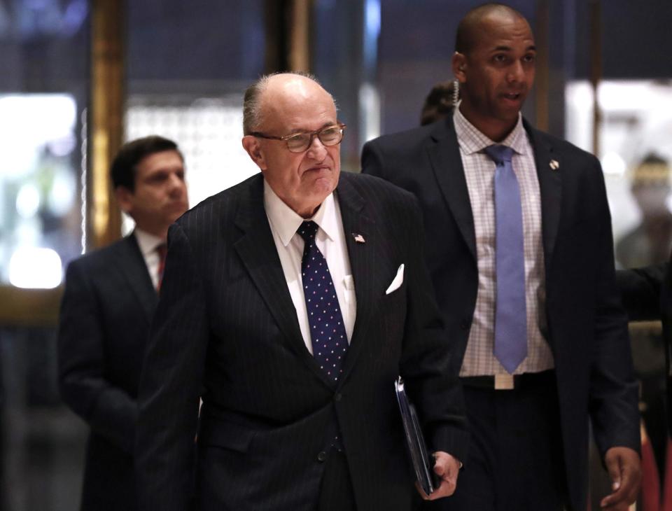 FILE- In this Nov. 16, 2016 file photo, former New York Mayor Rudy Giuliani arrives at Trump Tower in New York. On Friday, Dec. 9, 2016, President-elect Donald Trump announced that Giuliani has removed his name from consideration for a cabinet position in the Trump administration. (AP Photo/Carolyn Kaster, File)