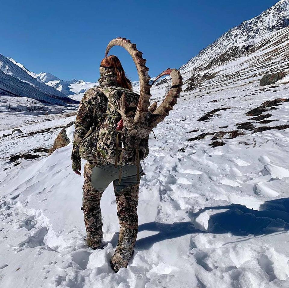 Ms Baulina pictured with the ibex's horns strapped to her back. Source: East2West News/ Australscope